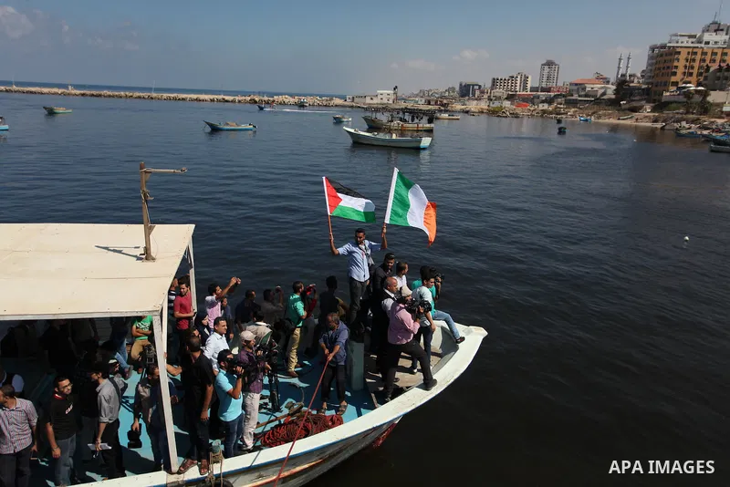 Palestinians show their solidarity with a Gaza-bound flotilla of international activists attempting to break the Israeli blockade on the Hamas-run Gaza Strip, on October 5, 2016 at the port in Gaza City. A group of women...