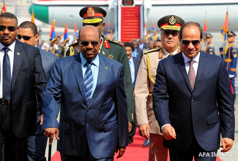 Egyptian President Abdel Fattah al-Sisi walks alongside with Sudanese President Omar al-Bashir upon his arrival at Cairo's international airport in Cairo, Egypt, on Oct. 05, 2016. Photo by Egyptian President Office