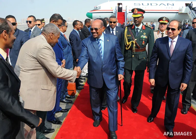 Egyptian President Abdel Fattah al-Sisi walks alongside with Sudanese President Omar al-Bashir upon his arrival at Cairo's international airport in Cairo, Egypt, on Oct. 05, 2016. Photo by Egyptian President Office