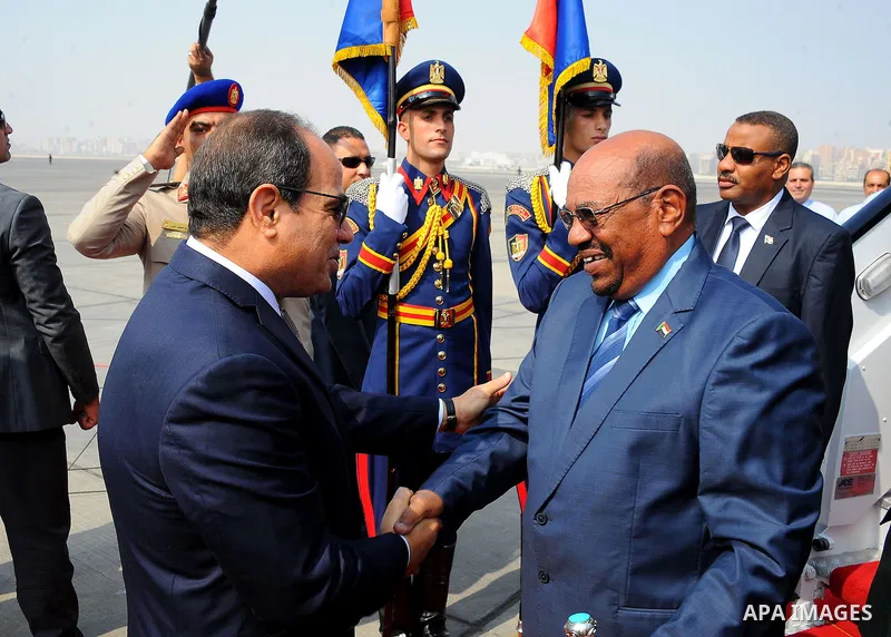 Egyptian President Abdel Fattah al-Sisi welcomes Sudanese President Omar al-Bashir upon his arrival at Cairo's international airport in Cairo, Egypt, on Oct. 05, 2016. Photo by Egyptian President Office