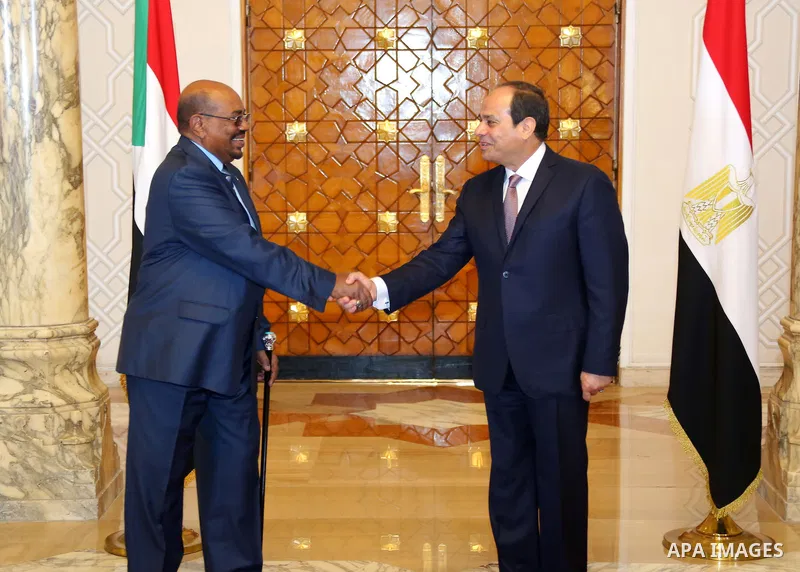 Egyptian President Abdel Fattah al-Sisi shake hands with Sudanese President Omar al-Bashir before a meeting in Cairo, Egypt, on Oct. 05, 2016. Photo by Egyptian President Office