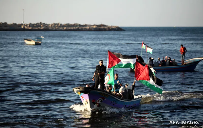 Palestinian women sail boats bearing their national flag in the port of Gaza City in support of the Gaza-bound flotilla of international female activists attempting to break the Israeli blockade on Gaza Strip on October...