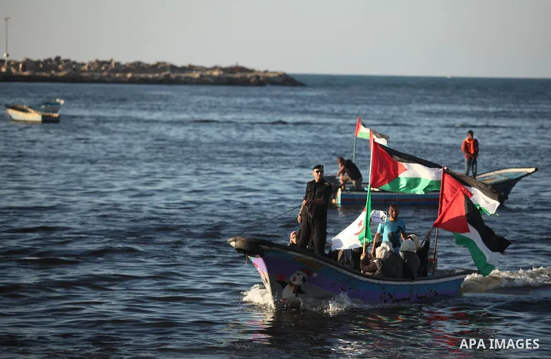 Palestinian women sail boats bearing their national flag in the port of Gaza City in support of the Gaza-bound flotilla of international female activists attempting to break the Israeli blockade on Gaza Strip on October...