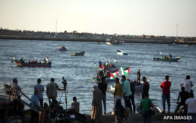 Palestinian women sail boats bearing their national flag in the port of Gaza City in support of the Gaza-bound flotilla of international female activists attempting to break the Israeli blockade on Gaza Strip on October...