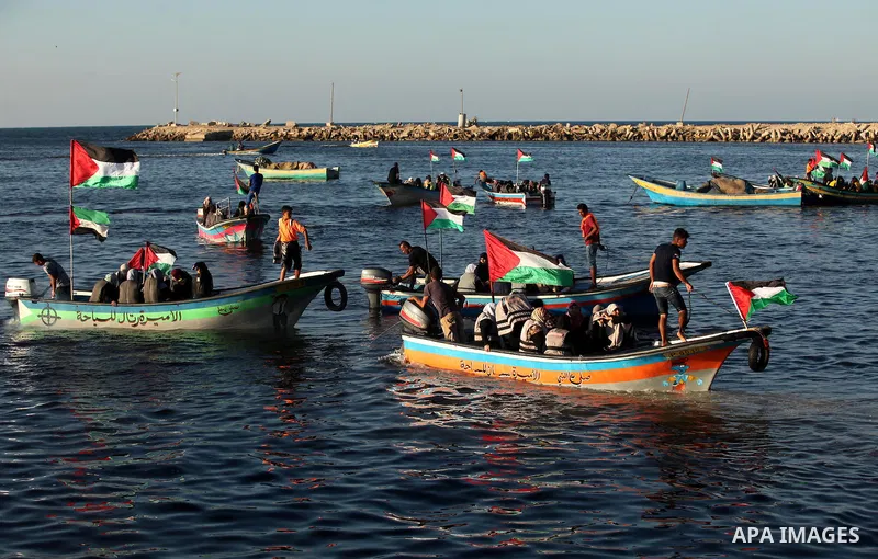 Palestinian women sail boats bearing their national flag in the port of Gaza City in support of the Gaza-bound flotilla of international female activists attempting to break the Israeli blockade on Gaza Strip on October...