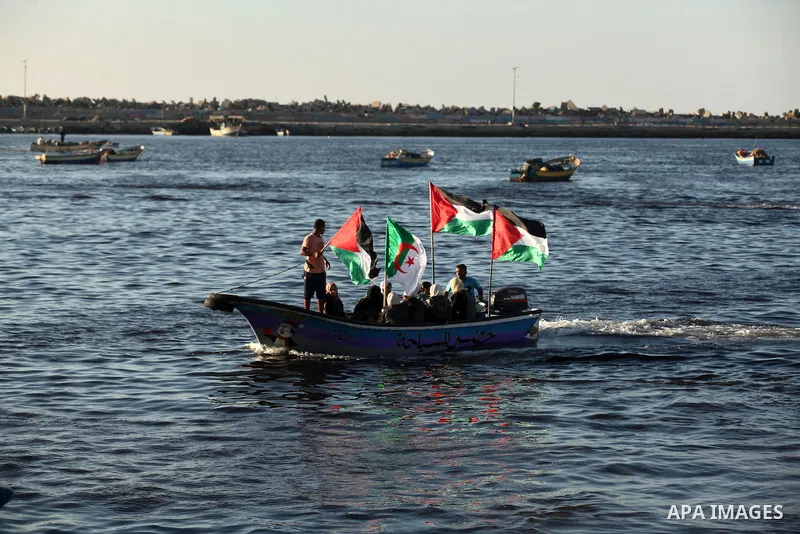 Palestinian women sail boats bearing their national flag in the port of Gaza City in support of the Gaza-bound flotilla of international female activists attempting to break the Israeli blockade on Gaza Strip on October...