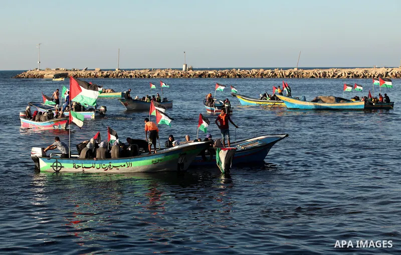 Palestinian women sail boats bearing their national flag in the port of Gaza City in support of the Gaza-bound flotilla of international female activists attempting to break the Israeli blockade on Gaza Strip on October...