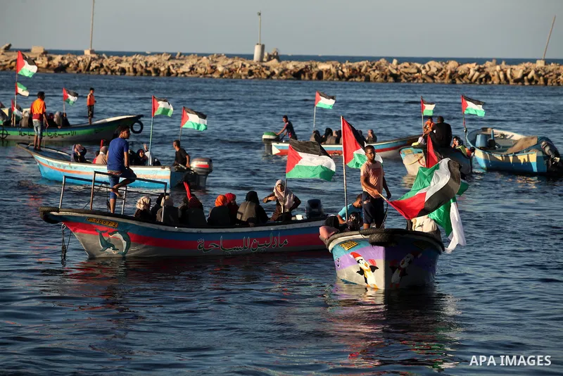 Palestinian women sail boats bearing their national flag in the port of Gaza City in support of the Gaza-bound flotilla of international female activists attempting to break the Israeli blockade on Gaza Strip on October...