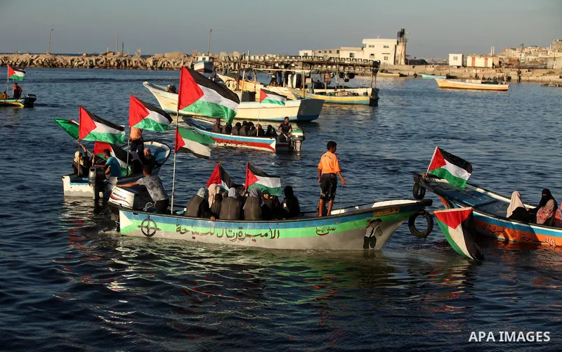 Palestinian women sail boats bearing their national flag in the port of Gaza City in support of the Gaza-bound flotilla of international female activists attempting to break the Israeli blockade on Gaza Strip on October...