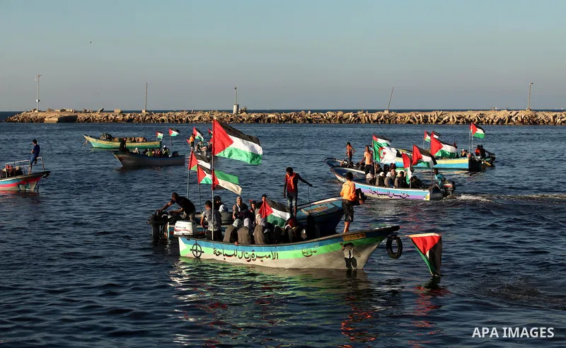 Palestinian women sail boats bearing their national flag in the port of Gaza City in support of the Gaza-bound flotilla of international female activists attempting to break the Israeli blockade on Gaza Strip on October...
