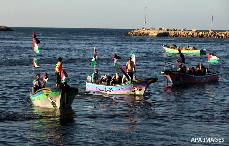 Palestinian women sail boats bearing their national flag in the port of Gaza City in support of the Gaza-bound flotilla of international female activists attempting to break the Israeli blockade on Gaza Strip on October...