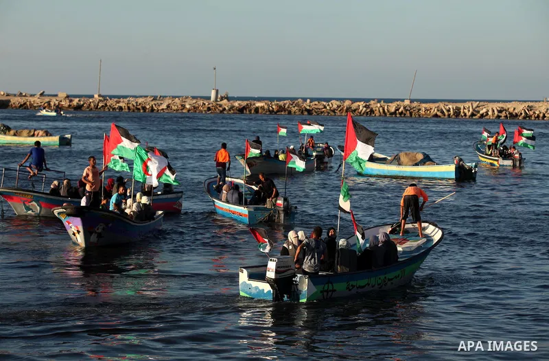 Palestinian women sail boats bearing their national flag in the port of Gaza City in support of the Gaza-bound flotilla of international female activists attempting to break the Israeli blockade on Gaza Strip on October...