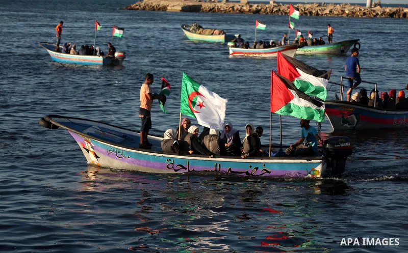 Palestinian women sail boats bearing their national flag in the port of Gaza City in support of the Gaza-bound flotilla of international female activists attempting to break the Israeli blockade on Gaza Strip on October...