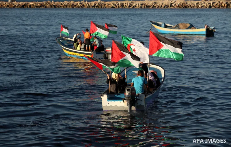 Palestinian women sail boats bearing their national flag in the port of Gaza City in support of the Gaza-bound flotilla of international female activists attempting to break the Israeli blockade on Gaza Strip on October...