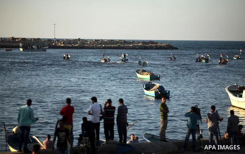 Palestinian women sail boats bearing their national flag in the port of Gaza City in support of the Gaza-bound flotilla of international female activists attempting to break the Israeli blockade on Gaza Strip on October...