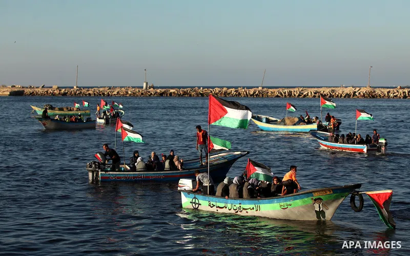 Palestinian women sail boats bearing their national flag in the port of Gaza City in support of the Gaza-bound flotilla of international female activists attempting to break the Israeli blockade on Gaza Strip on October...
