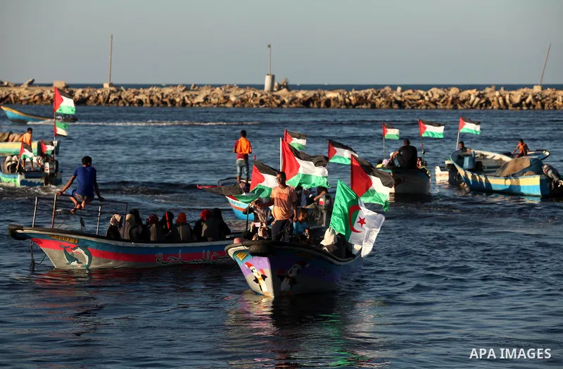 Palestinian women sail boats bearing their national flag in the port of Gaza City in support of the Gaza-bound flotilla of international female activists attempting to break the Israeli blockade on Gaza Strip on October...