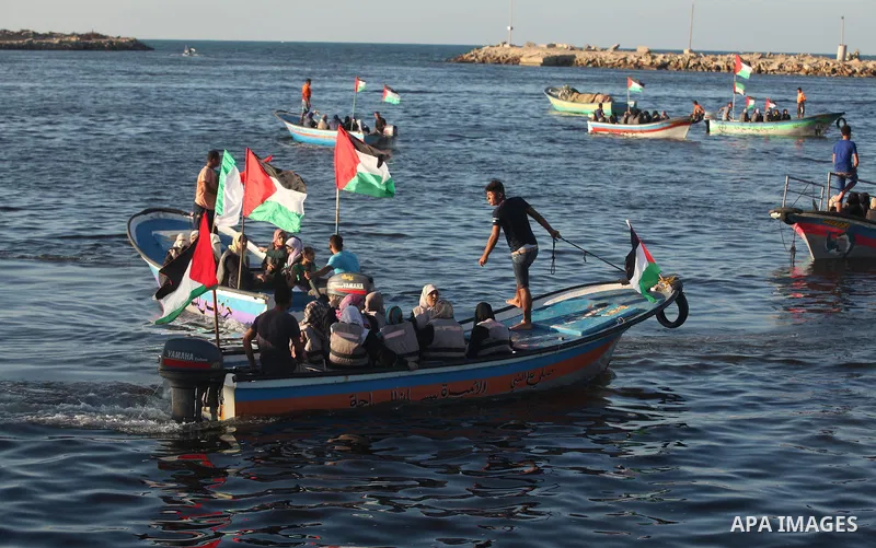 Palestinian women sail boats bearing their national flag in the port of Gaza City in support of the Gaza-bound flotilla of international female activists attempting to break the Israeli blockade on Gaza Strip on October...