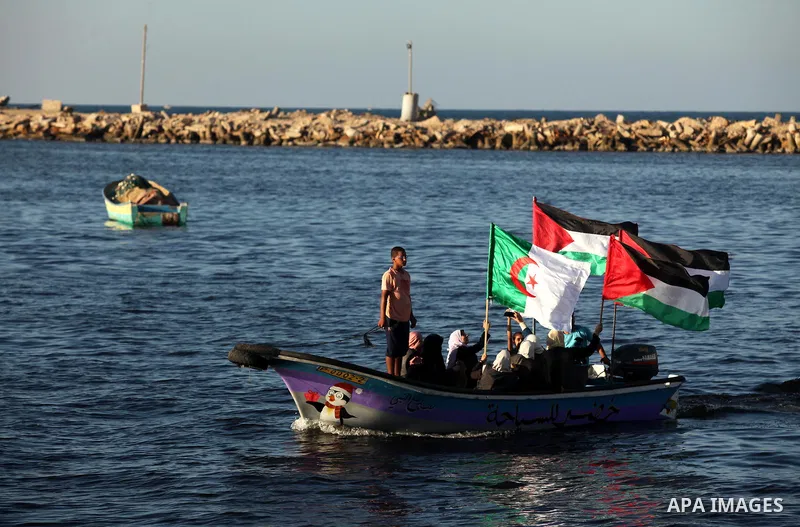 Palestinian women sail boats bearing their national flag in the port of Gaza City in support of the Gaza-bound flotilla of international female activists attempting to break the Israeli blockade on Gaza Strip on October...