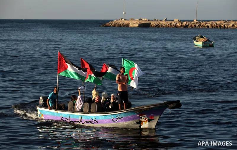Palestinian women sail boats bearing their national flag in the port of Gaza City in support of the Gaza-bound flotilla of international female activists attempting to break the Israeli blockade on Gaza Strip on October...