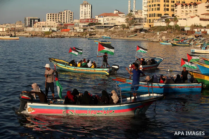 Palestinian women sail boats bearing their national flag in the port of Gaza City in support of the Gaza-bound flotilla of international female activists attempting to break the Israeli blockade on Gaza Strip on October...