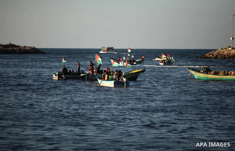 Palestinian women sail boats bearing their national flag in the port of Gaza City in support of the Gaza-bound flotilla of international female activists attempting to break the Israeli blockade on Gaza Strip on October...