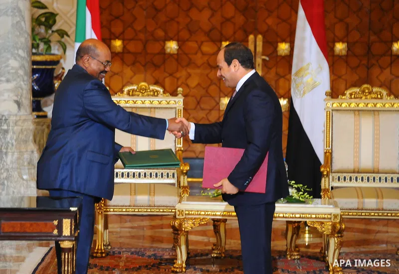 Egyptian President Abdel Fattah al-Sisi shake hands with Sudanese President Omar al-Bashir before a meeting in Cairo, Egypt, on Oct. 05, 2016. Photo by Egyptian President Office