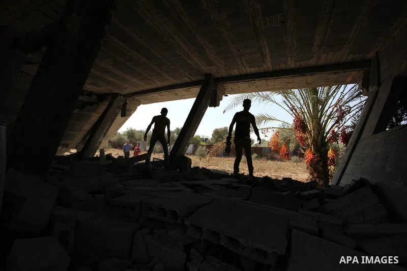 Palestinians inspect the scene of what witnesses said was an Israeli air strike carried out on Wednesday, east of Gaza City October 6, 2016. Photo by Ashraf Amra