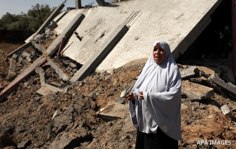 Palestinians inspect the scene of what witnesses said was an Israeli air strike carried out on Wednesday, east of Gaza City October 6, 2016. Photo by Ashraf Amra