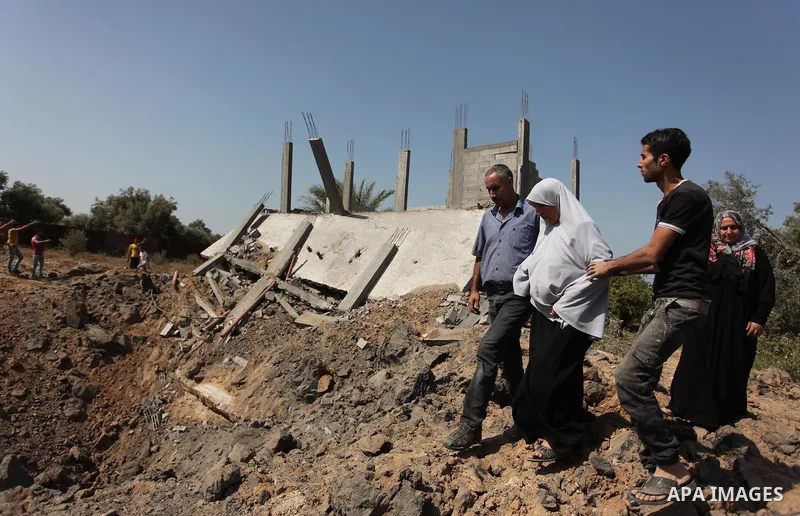 Palestinians inspect the scene of what witnesses said was an Israeli air strike carried out on Wednesday, east of Gaza City October 6, 2016. Photo by Ashraf Amra