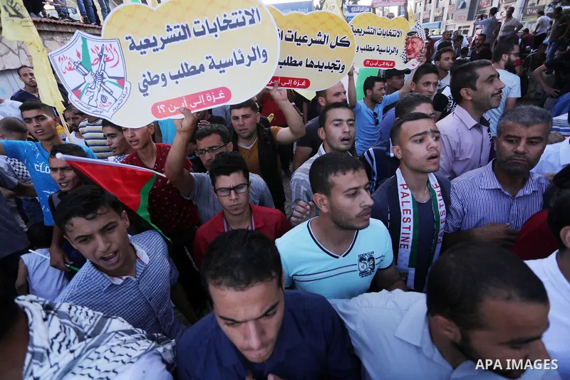 Palestinians who support Palestinian senior Fatah official Mohammed Dahlan, hold banners and national flags during a protest against Palestinian President Mahmoud Abbas in Gaza City on Oct. 06, 2016. Photo by Mohammed As...