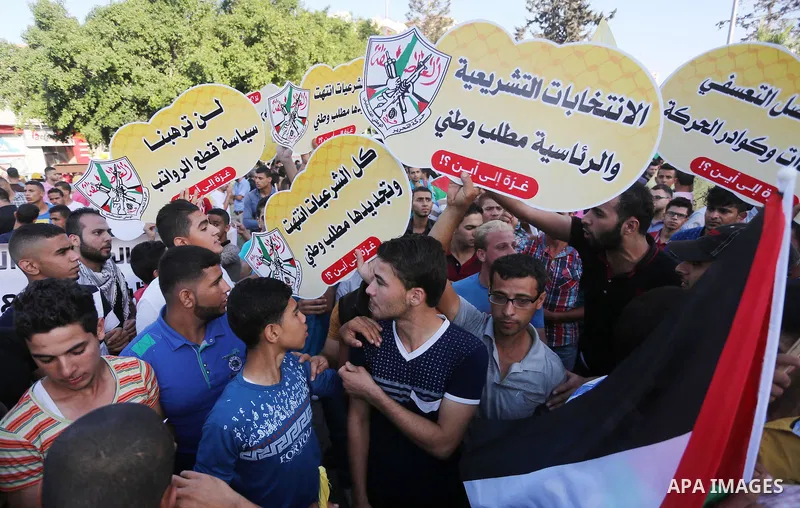 Palestinians who support Palestinian senior Fatah official Mohammed Dahlan, hold banners and national flags during a protest against Palestinian President Mahmoud Abbas in Gaza City on Oct. 06, 2016. Photo by Mohammed As...