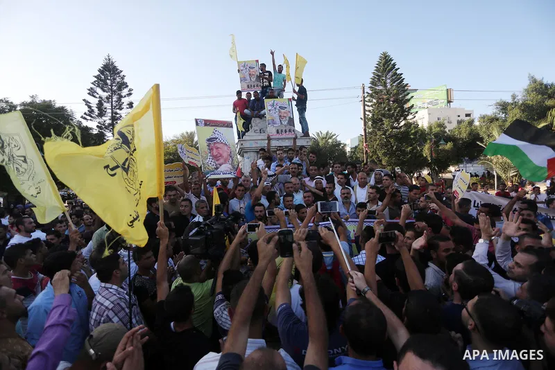 Palestinians who support Palestinian senior Fatah official Mohammed Dahlan, hold banners and national flags during a protest against Palestinian President Mahmoud Abbas in Gaza City on Oct. 06, 2016. Photo by Mohammed As...