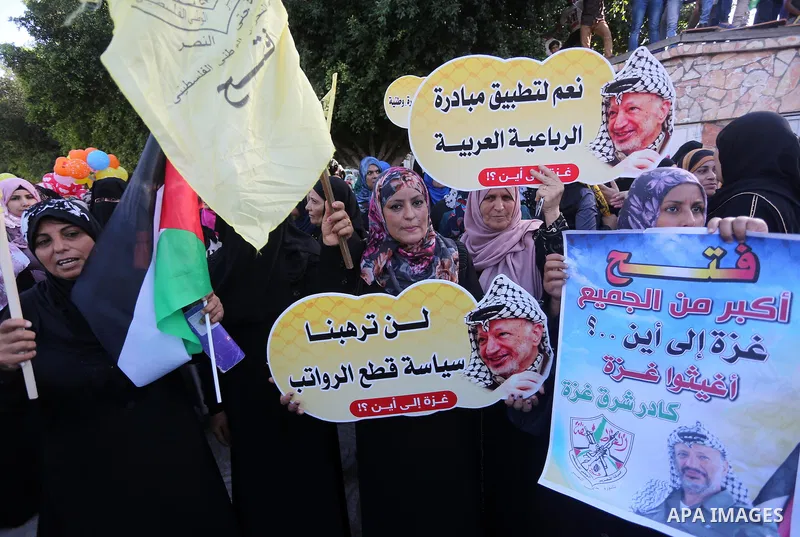 Palestinians who support Palestinian senior Fatah official Mohammed Dahlan, hold banners and national flags during a protest against Palestinian President Mahmoud Abbas in Gaza City on Oct. 06, 2016. Photo by Mohammed As...