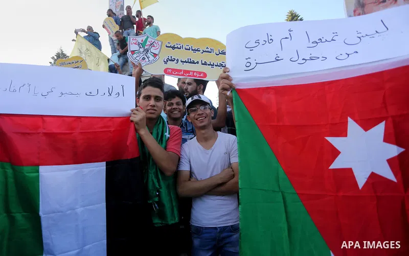 Palestinians who support Palestinian senior Fatah official Mohammed Dahlan, hold banners and national flags during a protest against Palestinian President Mahmoud Abbas in Gaza City on Oct. 06, 2016. Photo by Mohammed As...