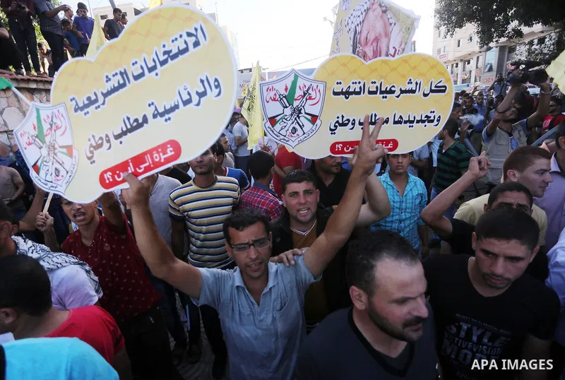 Palestinians who support Palestinian senior Fatah official Mohammed Dahlan, hold banners and national flags during a protest against Palestinian President Mahmoud Abbas in Gaza City on Oct. 06, 2016. Photo by Mohammed As...