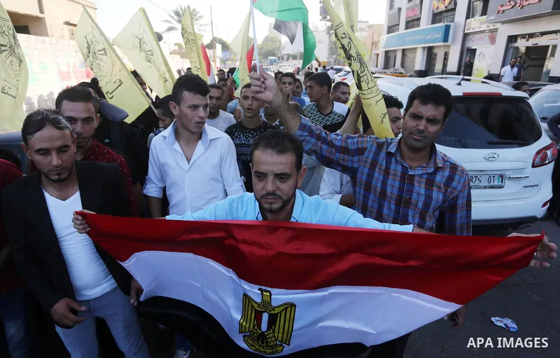 Palestinians who support Palestinian senior Fatah official Mohammed Dahlan, hold banners and national flags during a protest against Palestinian President Mahmoud Abbas in Gaza City on Oct. 06, 2016. Photo by Mohammed As...