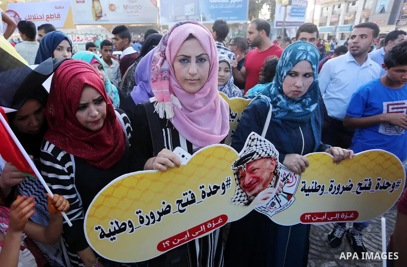 Palestinians who support Palestinian senior Fatah official Mohammed Dahlan, hold banners and national flags during a protest against Palestinian President Mahmoud Abbas in Gaza City on Oct. 06, 2016. Photo by Mohammed As...