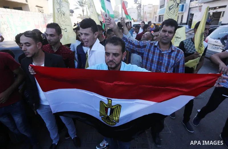 Palestinians who support Palestinian senior Fatah official Mohammed Dahlan, hold banners and national flags during a protest against Palestinian President Mahmoud Abbas in Gaza City on Oct. 06, 2016. Photo by Mohammed As...