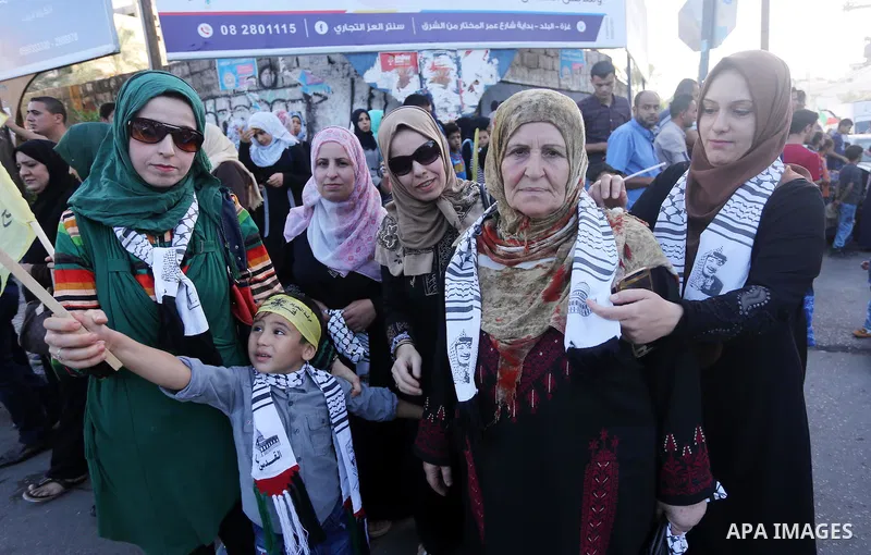 Palestinians who support Palestinian senior Fatah official Mohammed Dahlan, hold banners and national flags during a protest against Palestinian President Mahmoud Abbas in Gaza City on Oct. 06, 2016. Photo by Mohammed As...