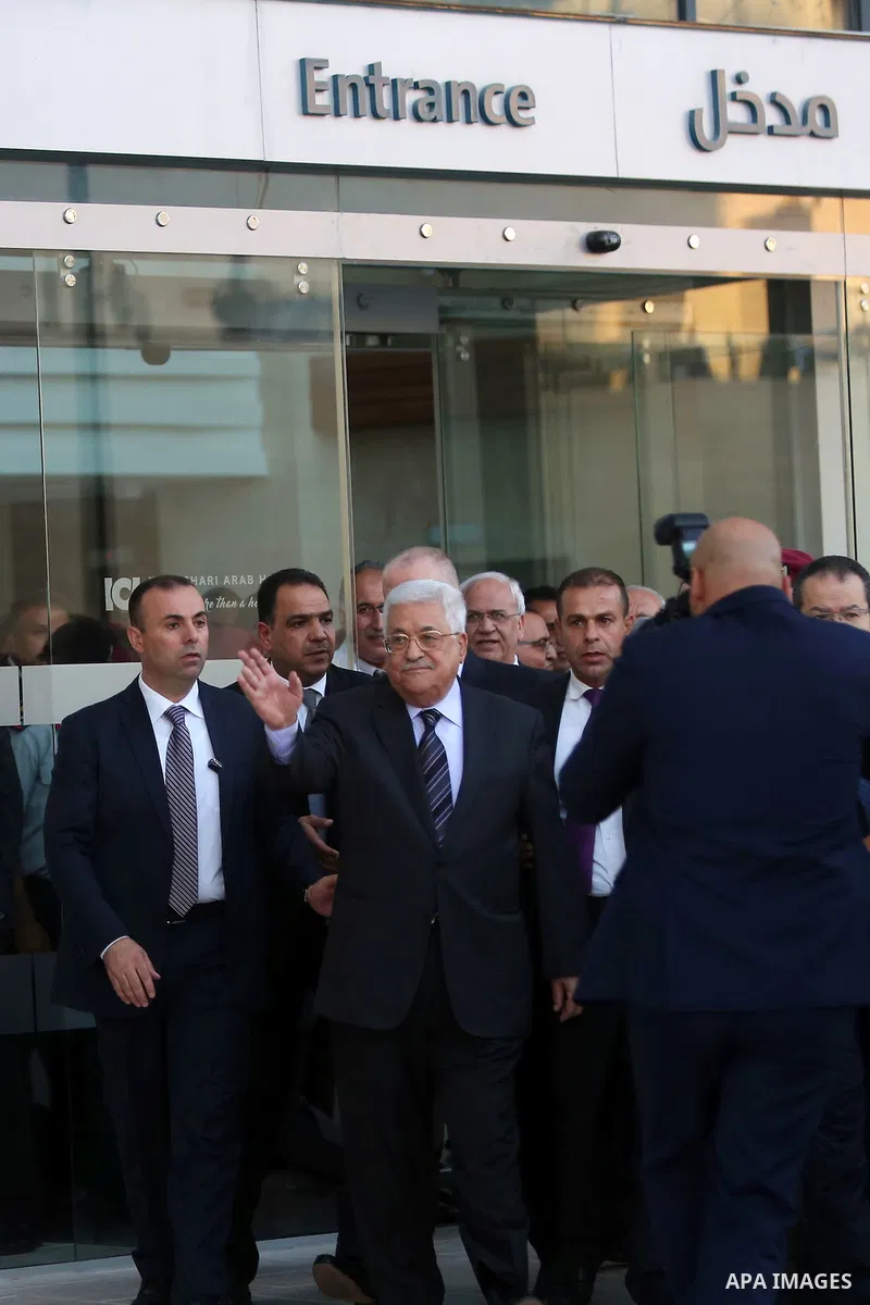 Palestinian President Mahmoud Abbas waves after leaving the hospital in the West Bank city of Ramallah, October 6, 2016. Photo by Shadi Hatem
