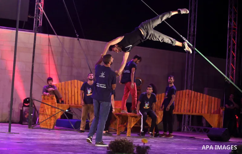 International and local artists, perform during the Palestine Circus Festival, in the West Bank city of Ramallah, on October 6, 2016. Photo by Shadi Hatem