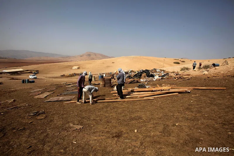 Palestinians inspect the remains of a house after it was demolished by Israeli authorities who said it was built without municipal permission on October 9, 2016 in the West Bank village of Khirbet ar-Ras al-Ahmar, north...