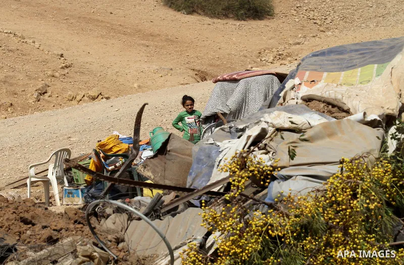 A Palestinian girl inspects the remains of a house after it was demolished by Israeli authorities who said it was built without municipal permission on October 9, 2016 in the West Bank village of Khirbet ar-Ras al-Ahmar,...