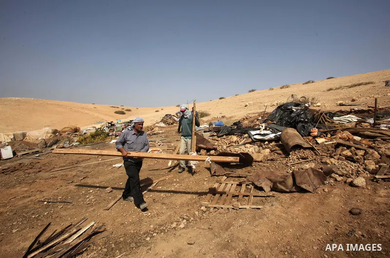 Palestinians inspect the remains of a house after it was demolished by Israeli authorities who said it was built without municipal permission on October 9, 2016 in the West Bank village of Khirbet ar-Ras al-Ahmar, north...