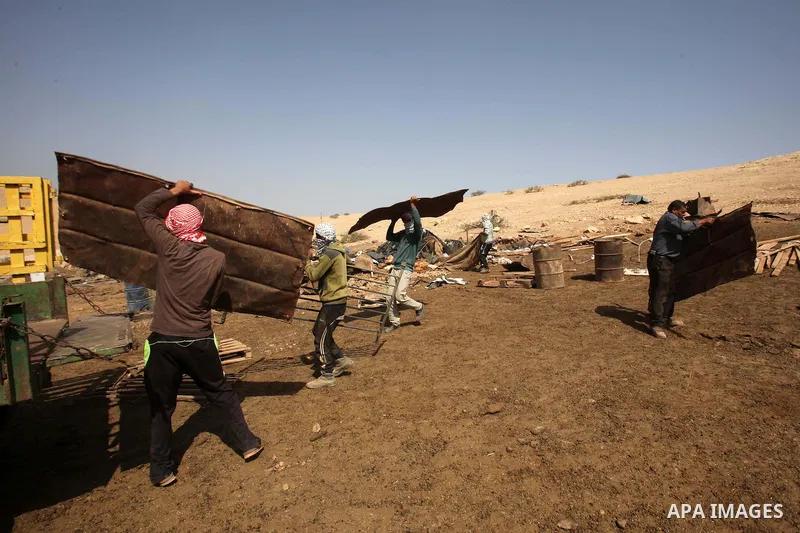 Palestinians inspect the remains of a house after it was demolished by Israeli authorities who said it was built without municipal permission on October 9, 2016 in the West Bank village of Khirbet ar-Ras al-Ahmar, north...