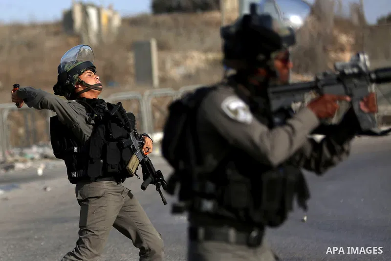 An Israeli border policeman is seen as he fired a tear gas canister during clashes with Palestinian protesters in the West Bank town of Al-Ram, near Jerusalem October 9, 2016. A Palestinian opened fire from a car in Jeru...