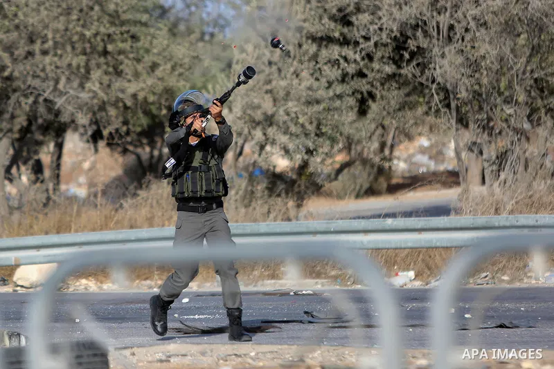 An Israeli border policeman is seen as he fired a tear gas canister during clashes with Palestinian protesters in the West Bank town of Al-Ram, near Jerusalem October 9, 2016. A Palestinian opened fire from a car in Jeru...