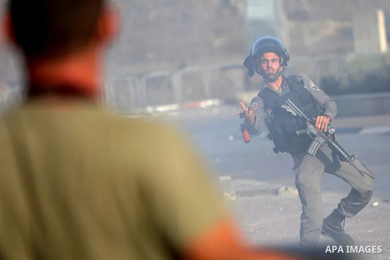 An Israeli border policeman is seen as he fired a tear gas canister during clashes with Palestinian protesters in the West Bank town of Al-Ram, near Jerusalem October 9, 2016. A Palestinian opened fire from a car in Jeru...