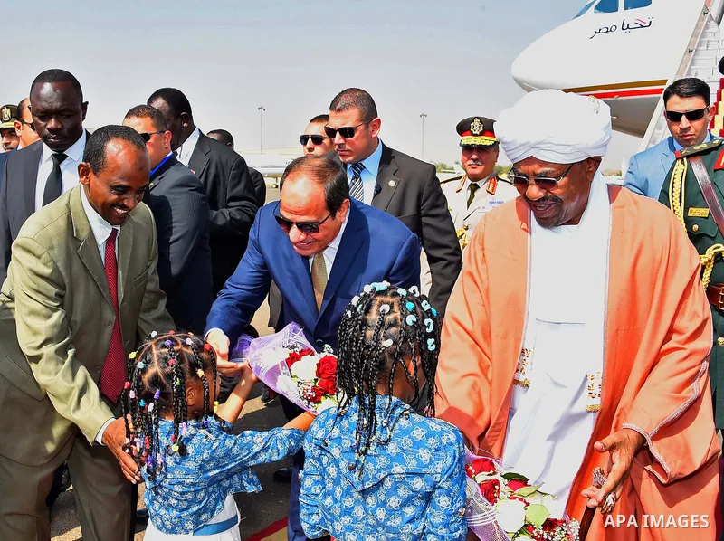 Sudanese President Omar al-Bashir welcomes Egyptian President Abdel Fattah al-Sisi upon his arrival at Khartoum Airport in Sudan on October 10, 2016. Photo by Egyptian President Office